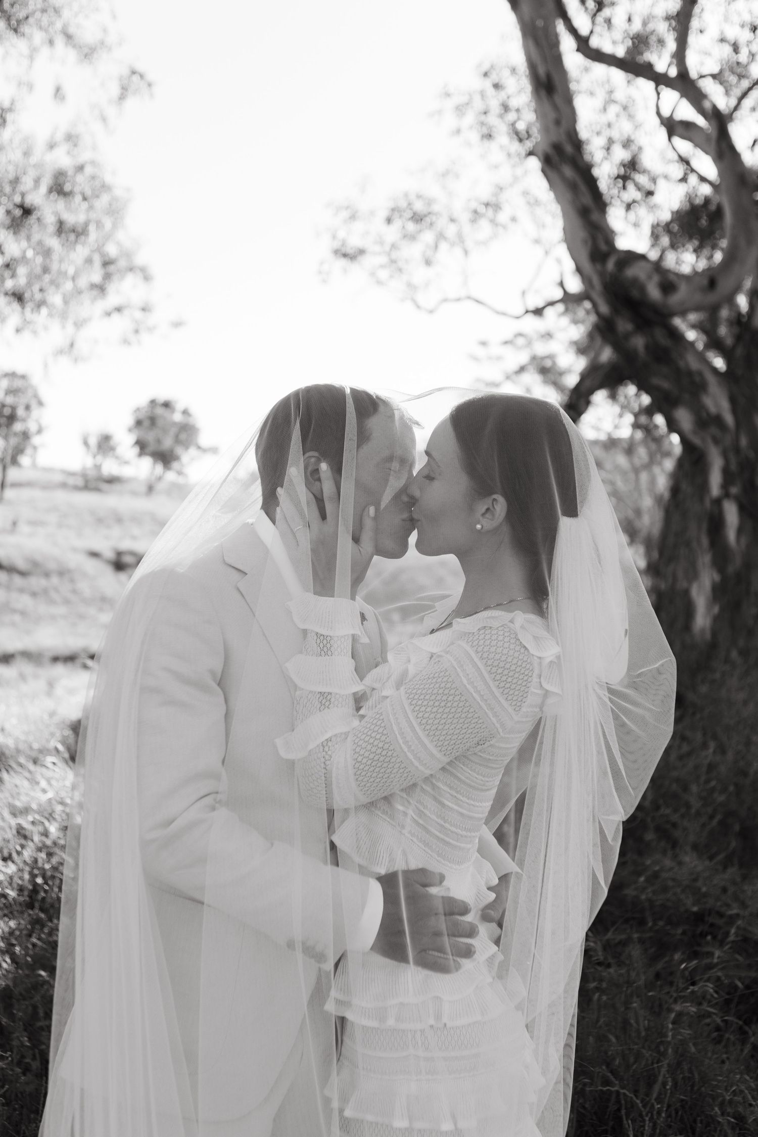 Bride and groom kissing at Scone NSW Country wedding