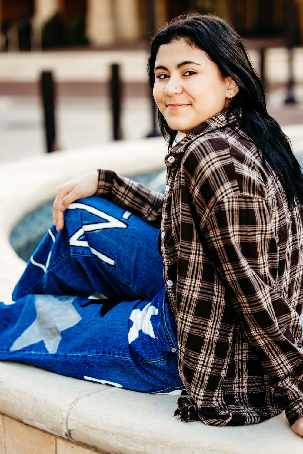 A series of photos showing someone in a plaid shirt lounging on outdoor steps with a blue star-patterned pillow.