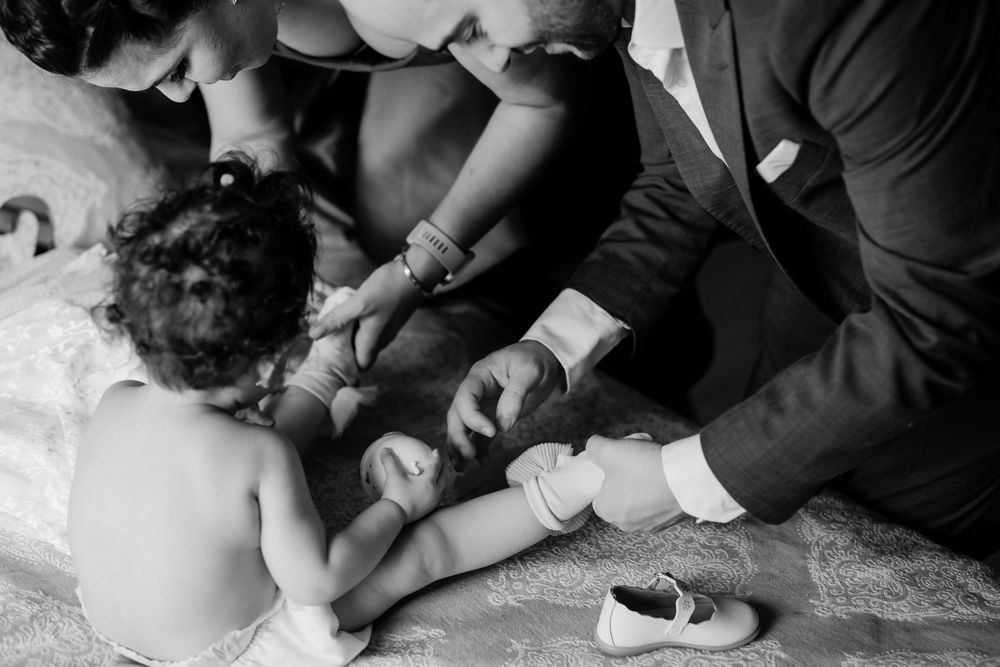 Artistic black and white sequence showing hands arranging fabric details.