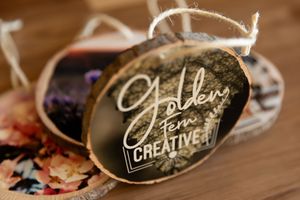 Handwritten calligraphy name tags with elegant script writing displayed on dark surfaces at a formal event.