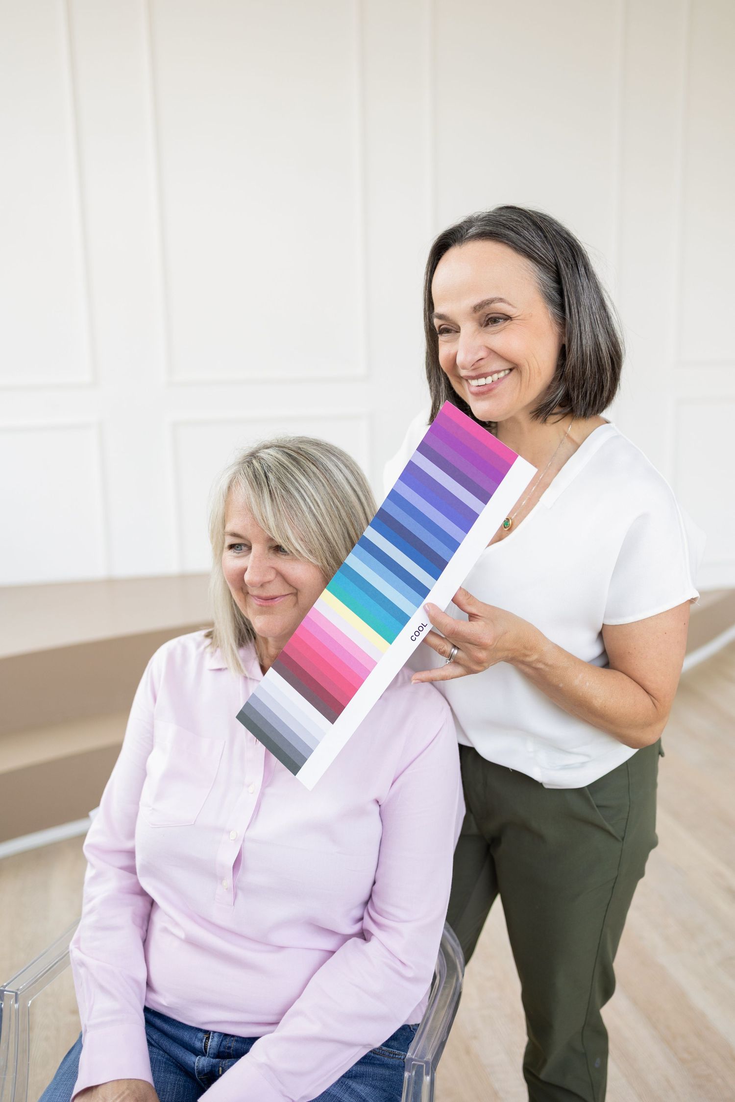 wardrobe stylist doing color analysis on older client during consultation for a branding photography photoshoot
