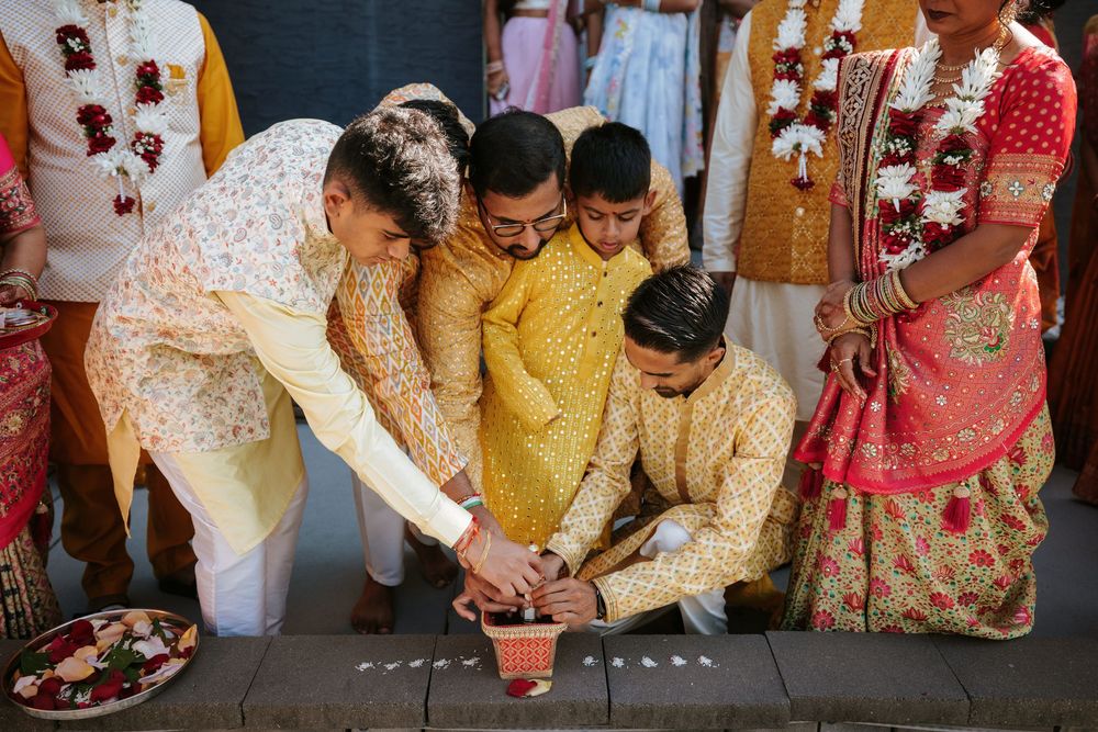 Colorfully dressed guests at an Indian wedding ceremony gather around traditional wedding rituals and customs.