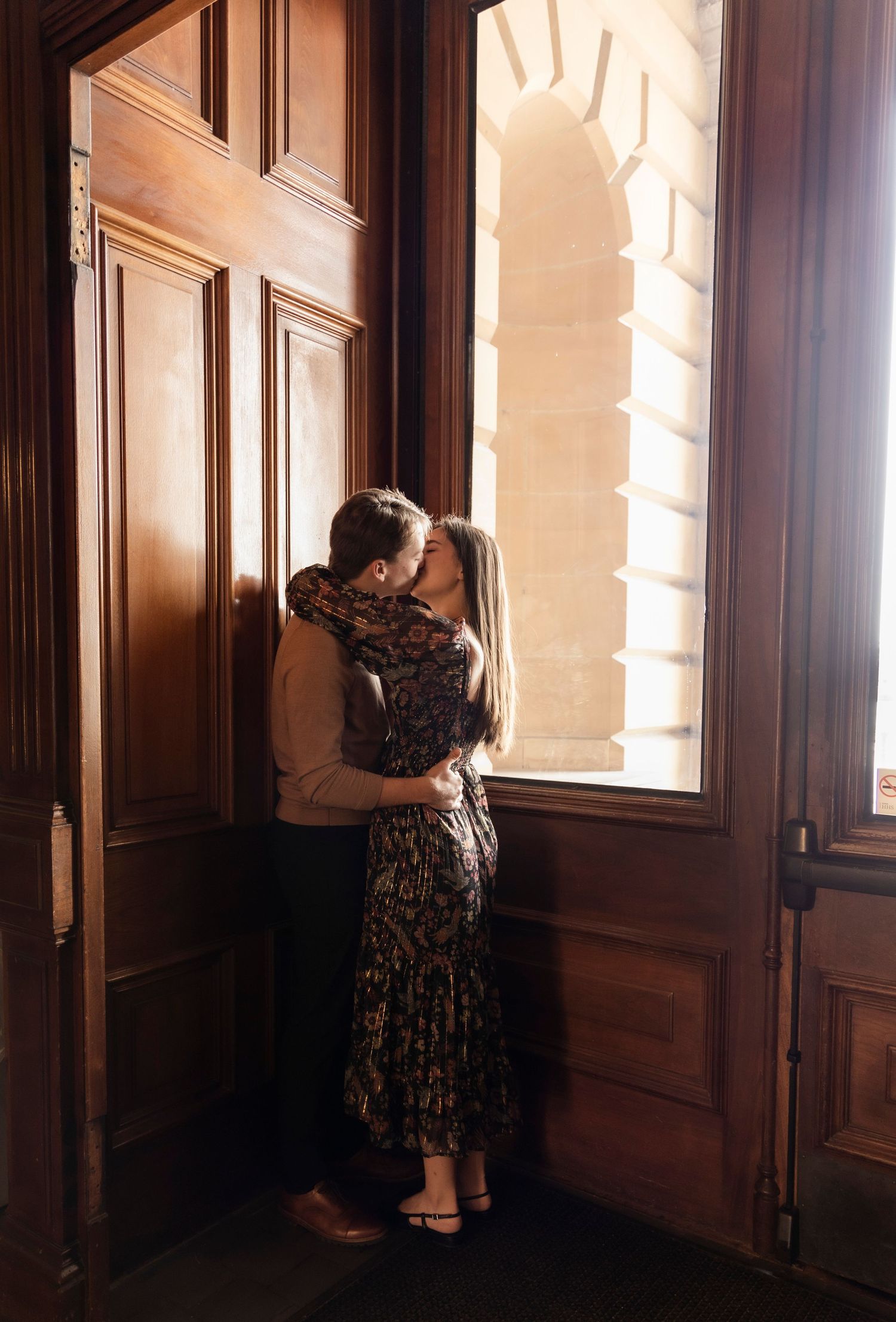 Couple embracing during their engagement session at the Iowa State Capital.