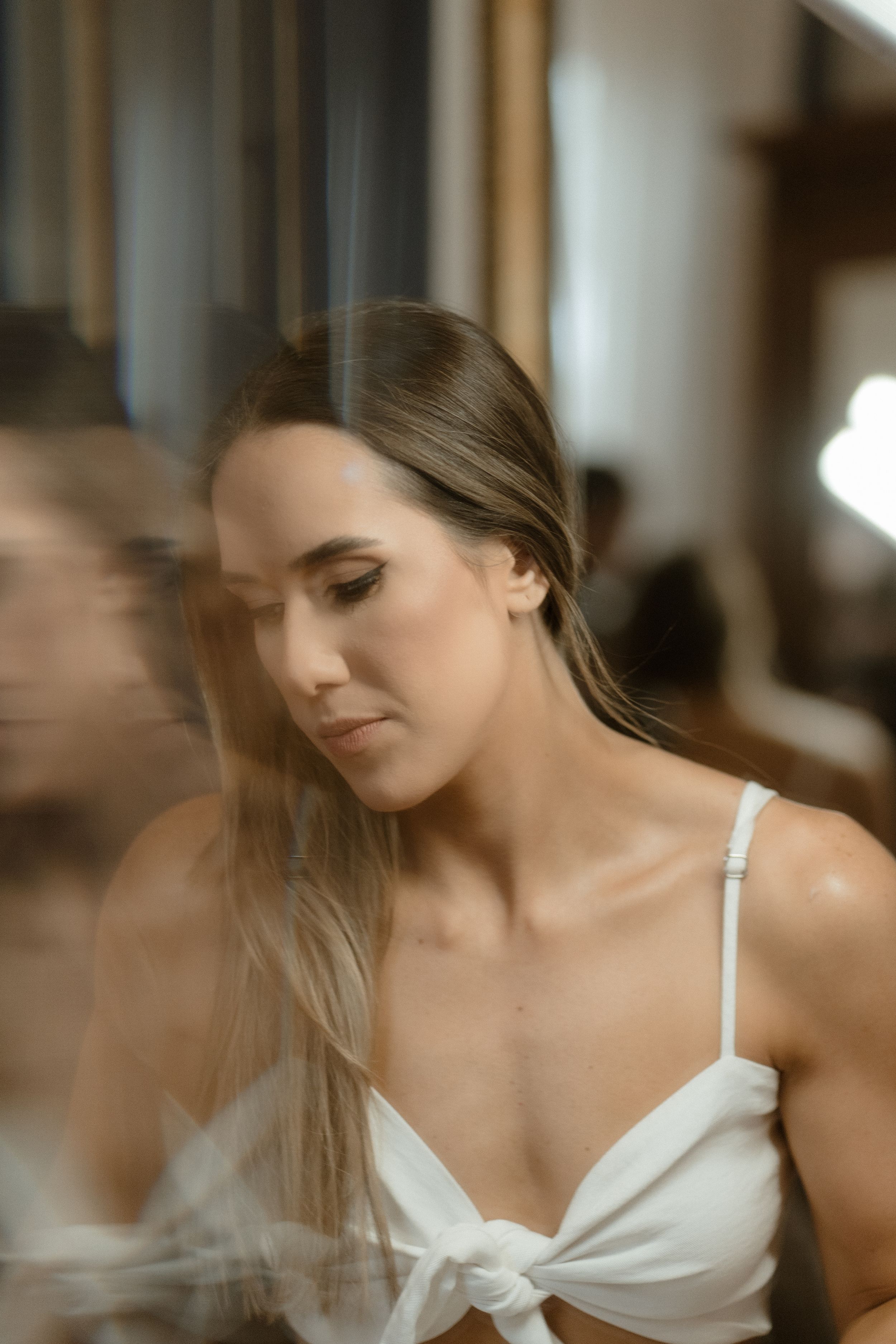 Dreamy soft focus portrait with natural window lighting in warm tones.