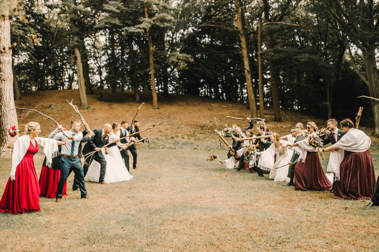 Wedding guests form two lines holding swords for a ceremony exit tradition.