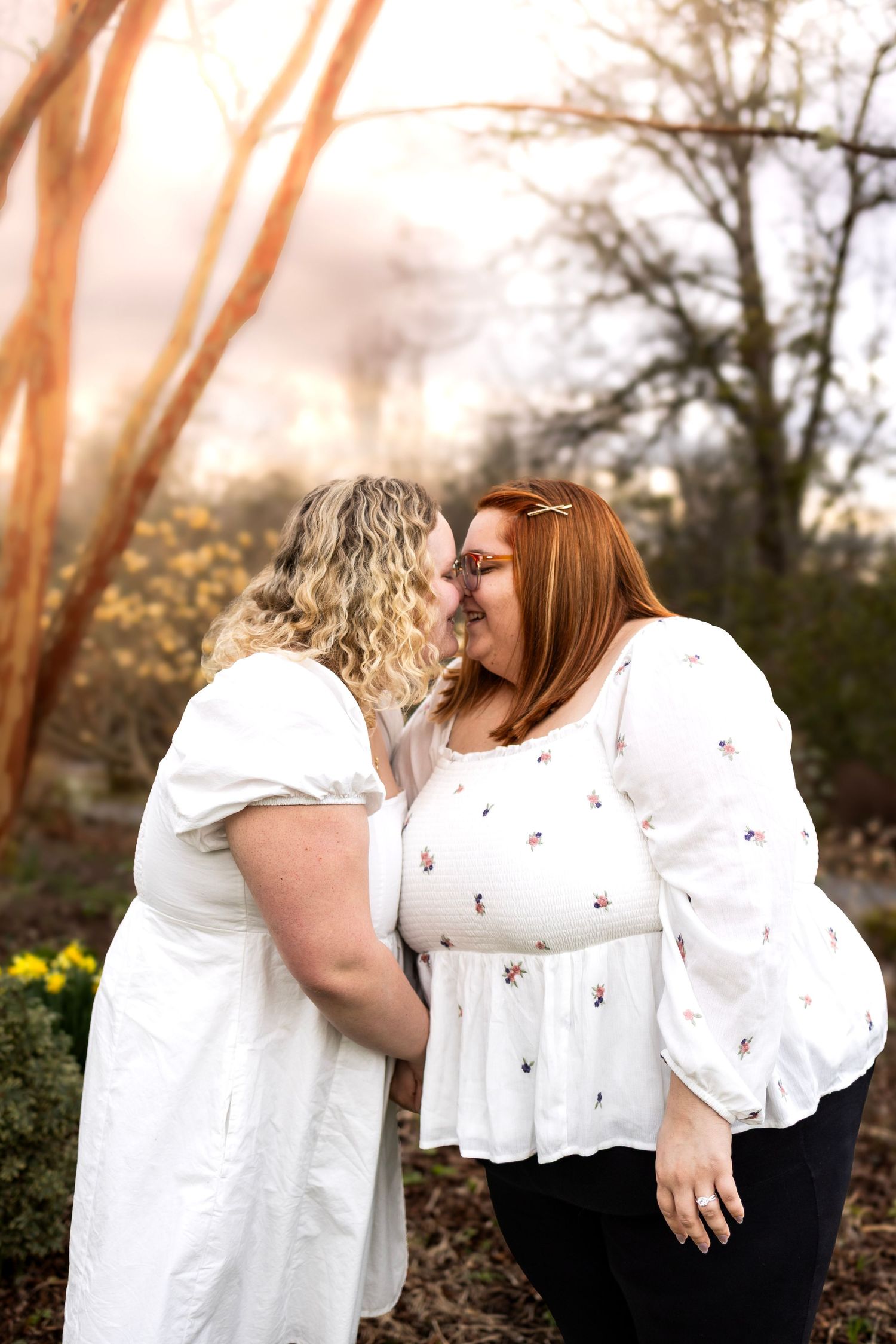 Intimate outdoor photo sequence showing two people in coordinated white outfits.