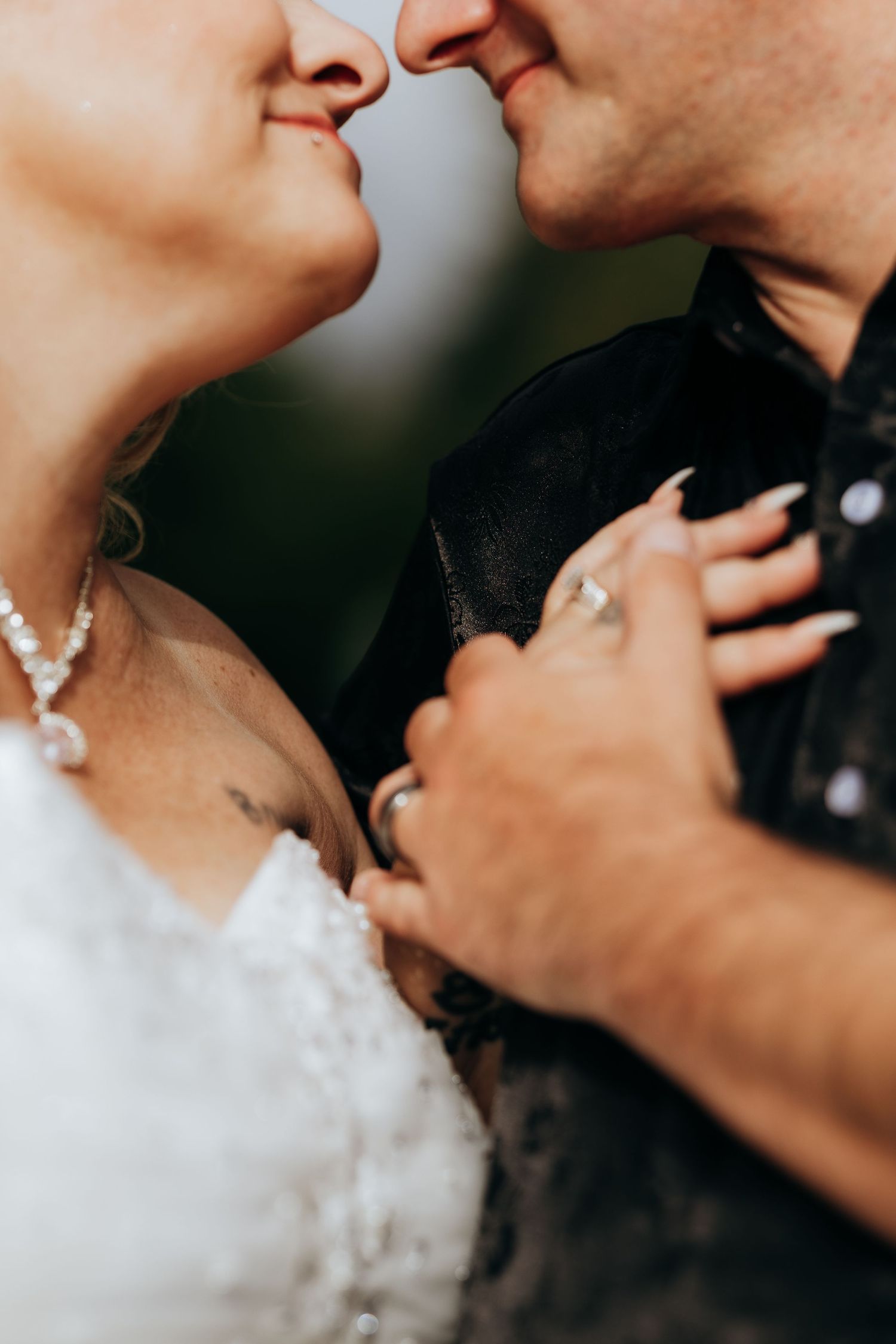 Close-up artistic shot of a couple's tender moment during their wedding day.