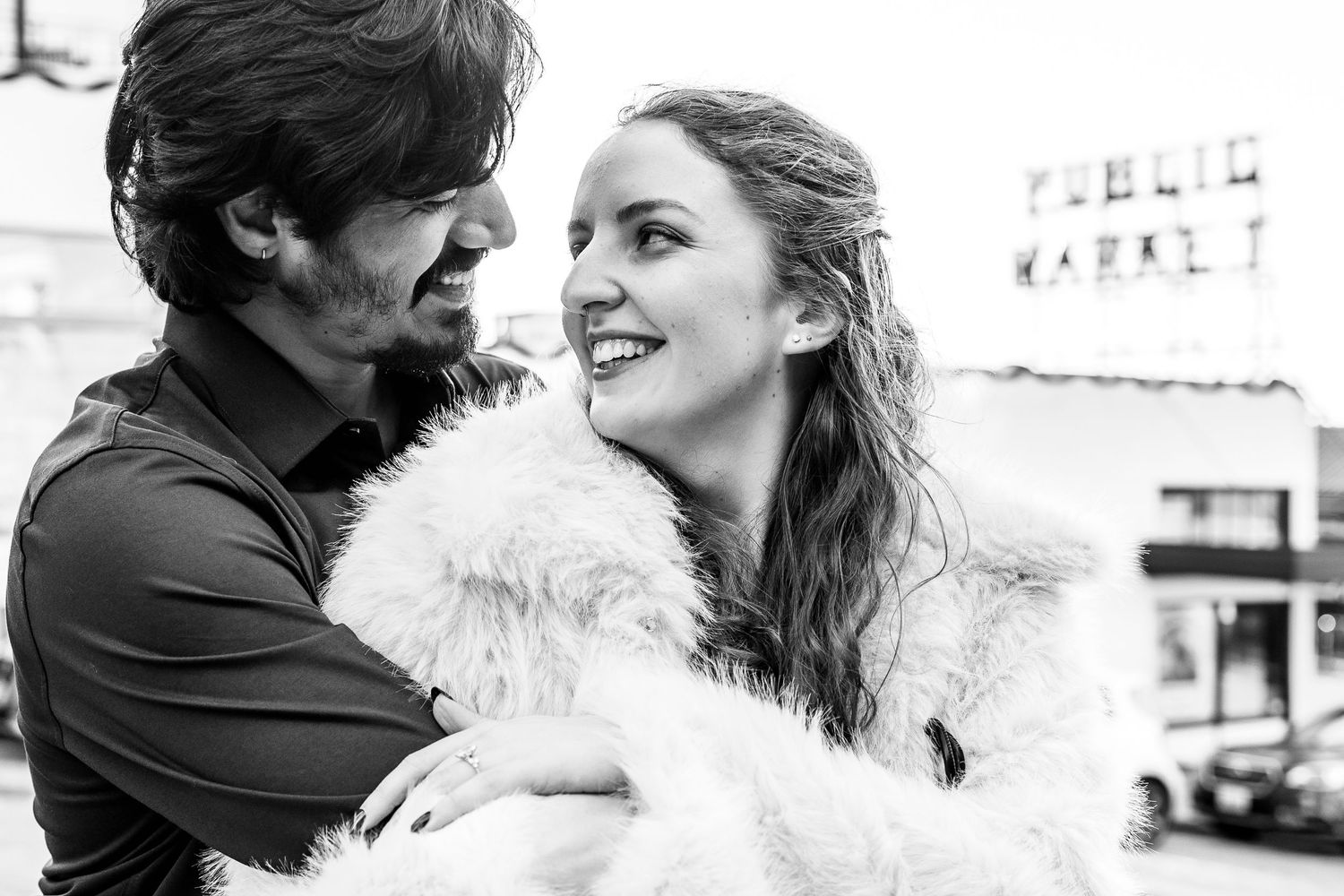 A black and white photo collage shows a couple embracing and sharing intimate moments in various candid poses.