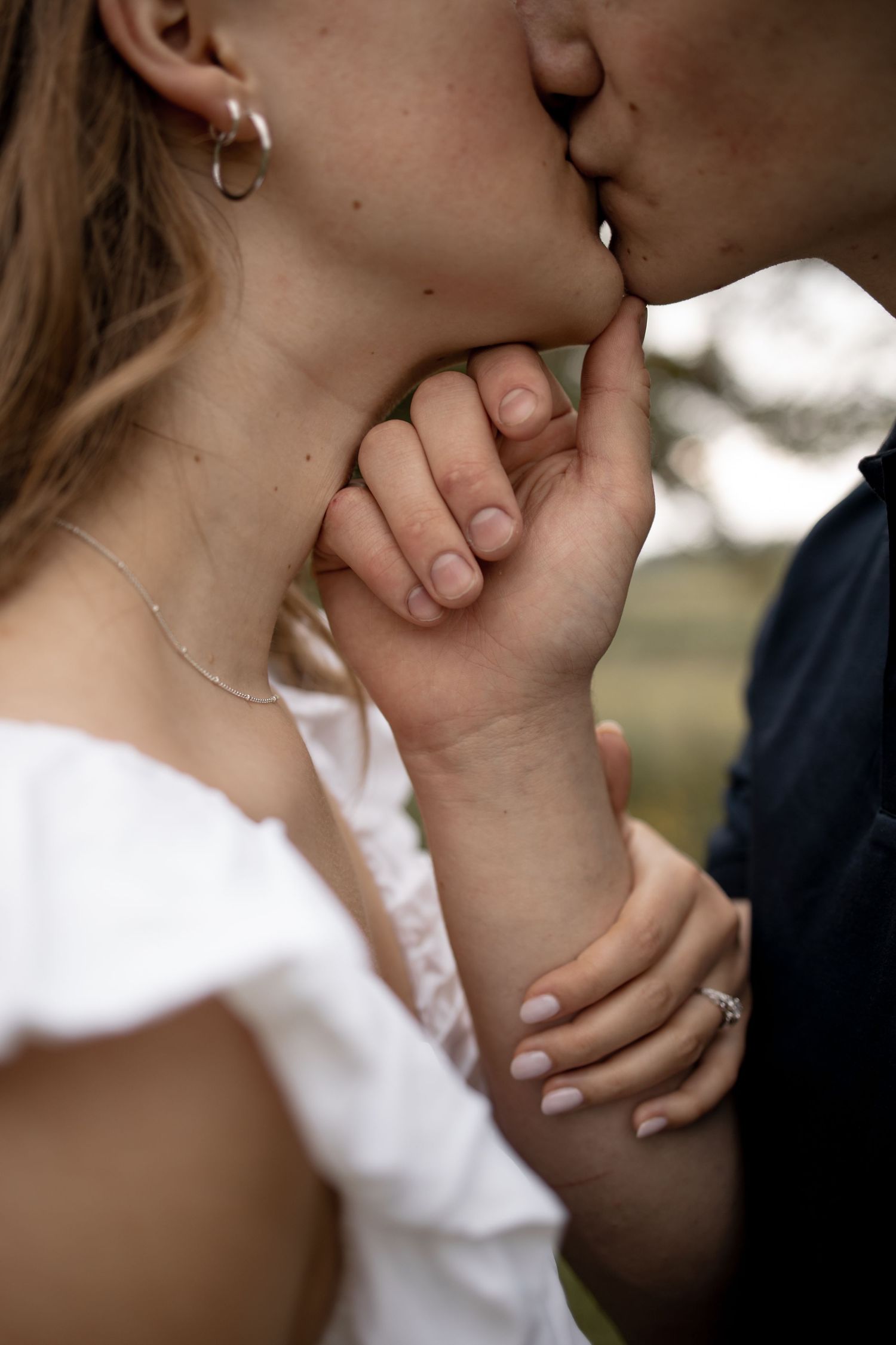 Close up shot of a romantic kiss in soft natural lighting.