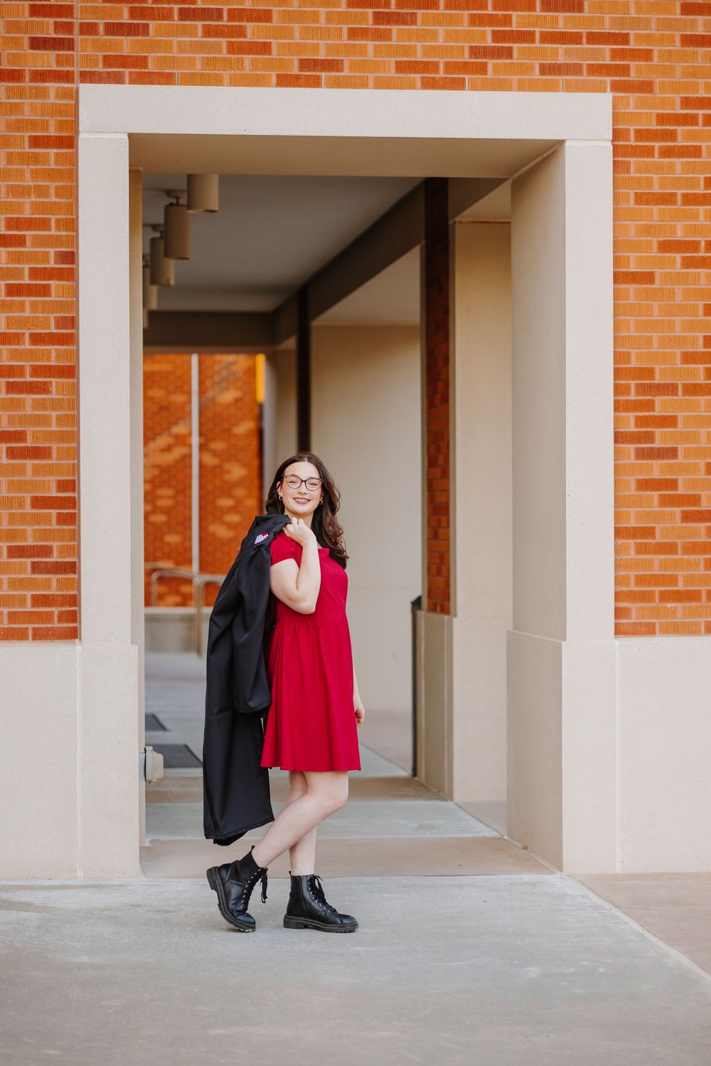 A series of five photos showing someone in a red top and black backpack posing against a brick wall with white columns.