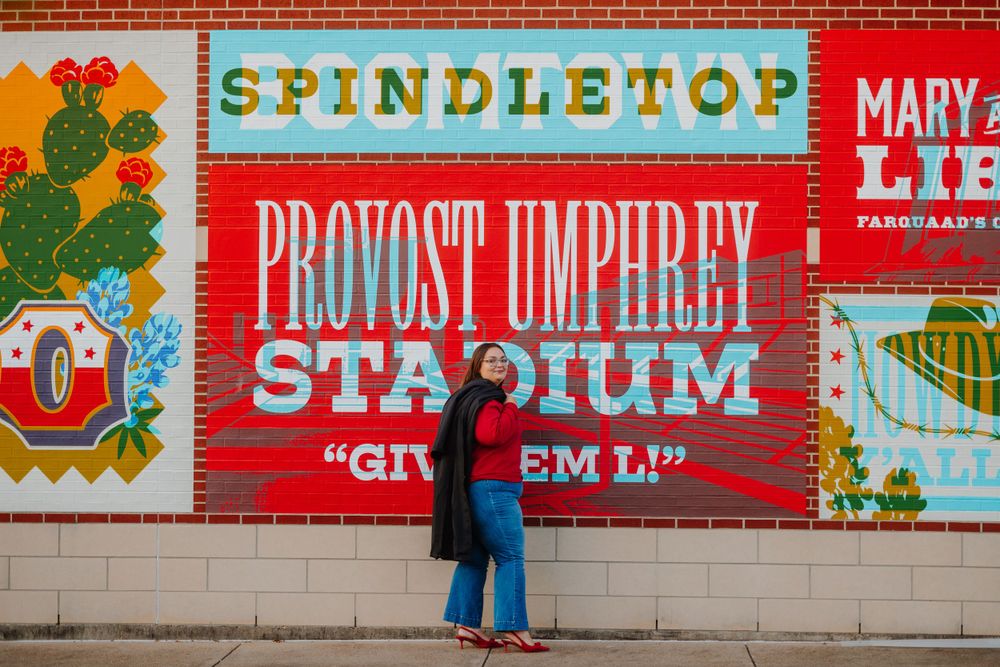 Colorful vintage-style murals and signs decorate an urban wall with retro aesthetic.