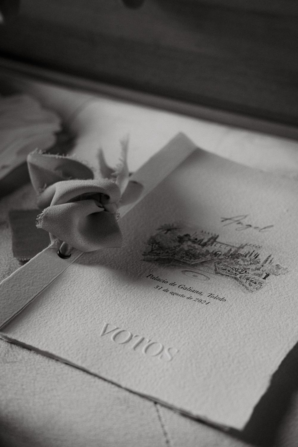 Wedding vows document with elegant calligraphy and a delicate flower on top.