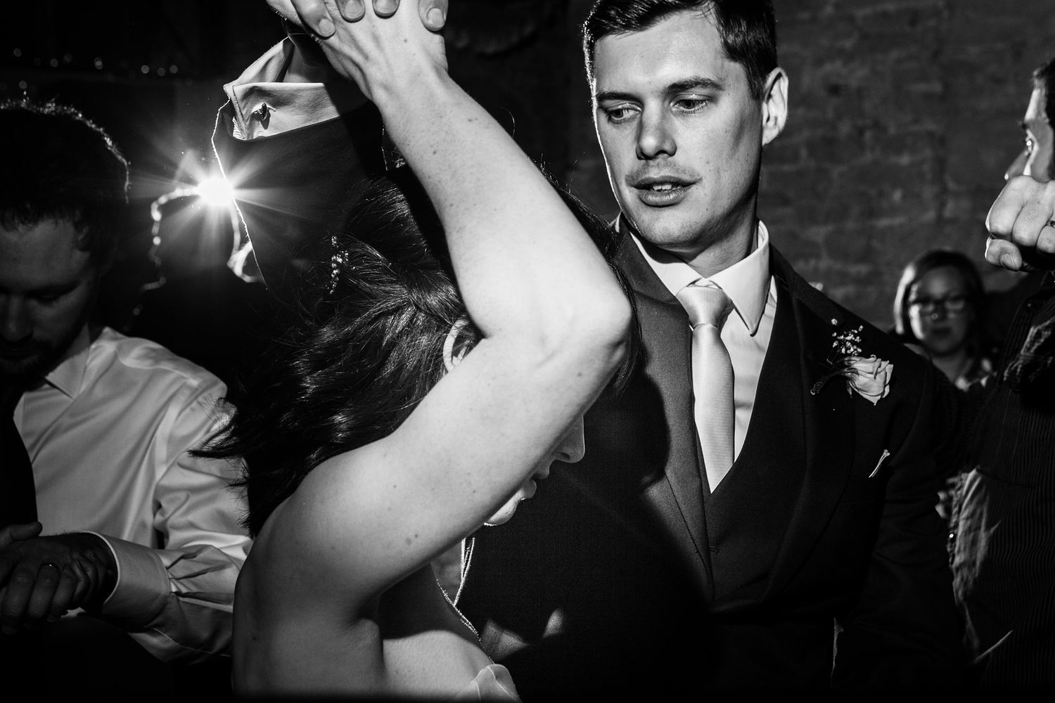 Black and white photos show people dancing and socializing at a Nova Scotia Barn wedding