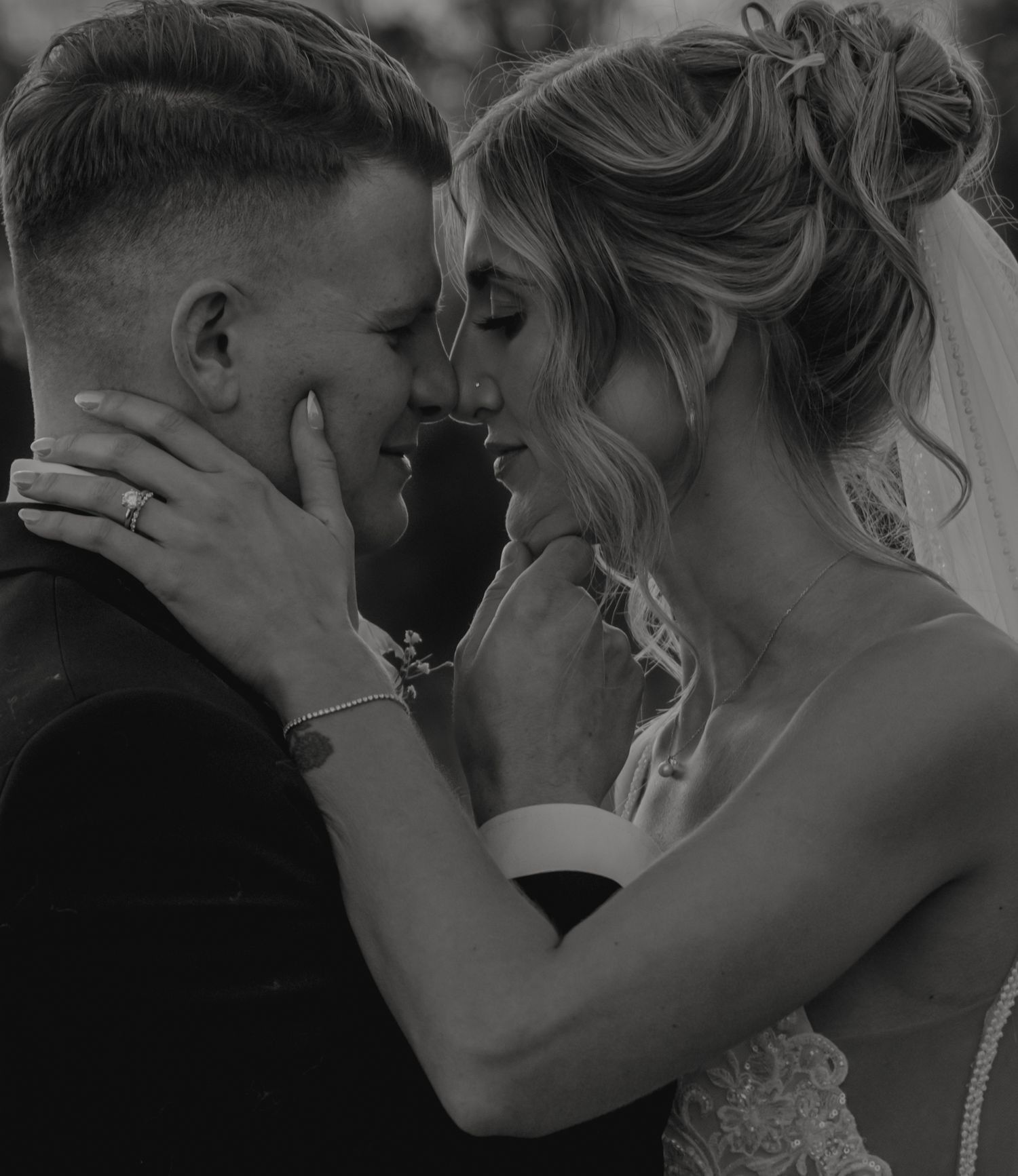 A romantic black and white photo series showing tender moments between a couple on their wedding day.