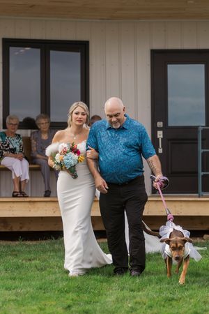 Bride walks down wedding aisle with father and dog during intimate romantic wedding at Hopewell Highlands, New Brunswick wedding photography