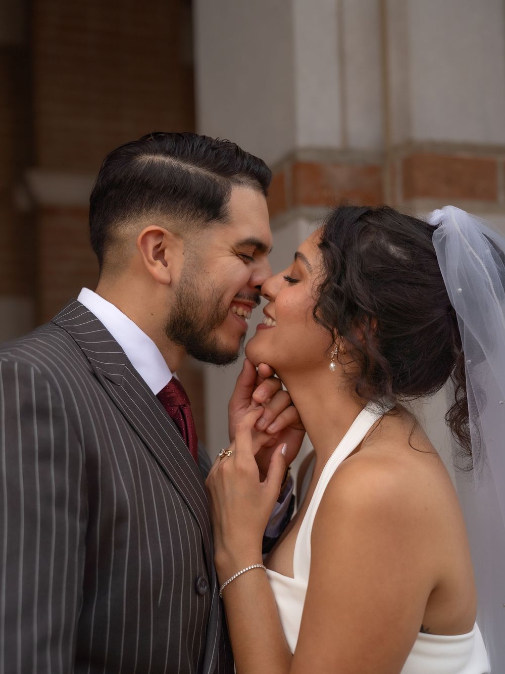 Wedding portraits of Rubi and Joe Yerena in front of Rice University’s iconic Lovett Hall, showing their love and connection.