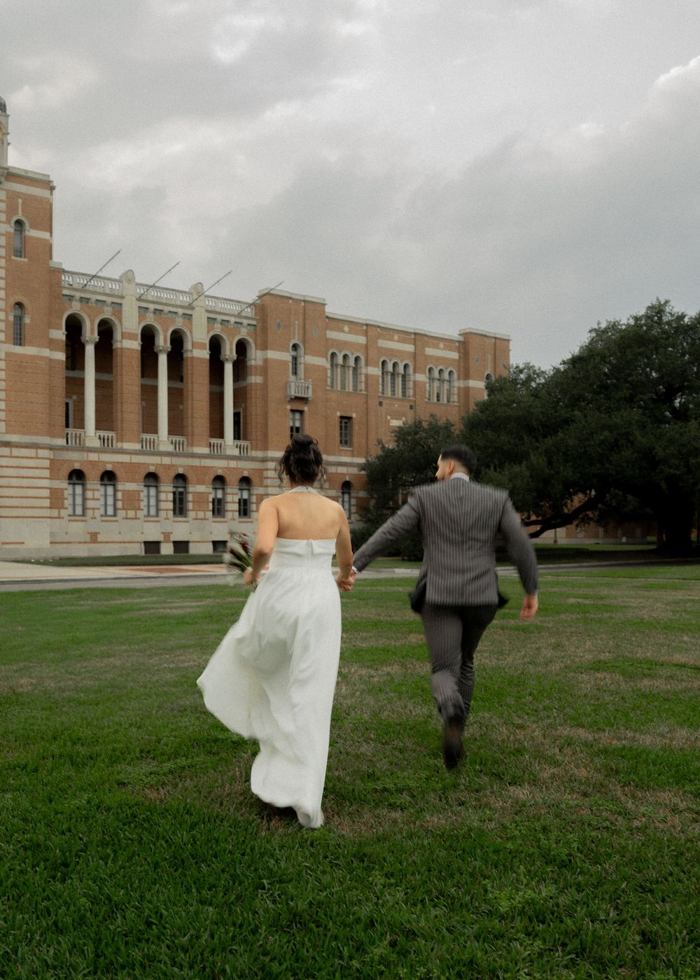 Wedding portraits of Rubi and Joe Yerena in front of Rice University’s iconic Lovett Hall, showing their love and connection.