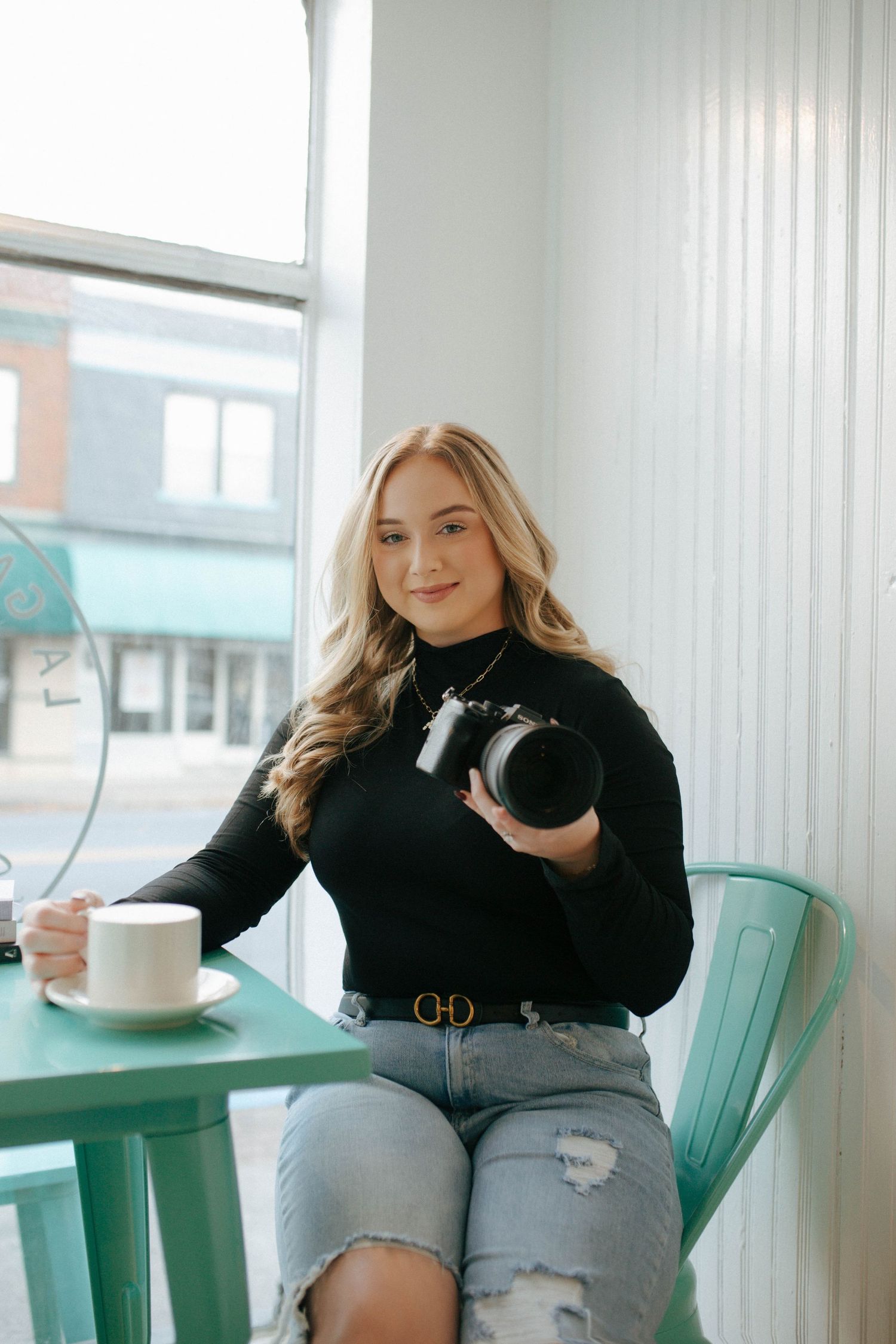 Casual coffee shop scene with turquoise chairs and bright interior decor.