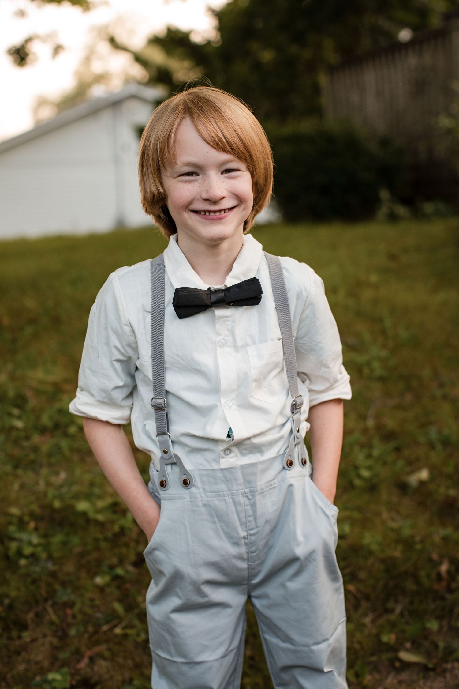 Natural family photography of a smiling child standing outdoors, photographed during a relaxed documentary family session