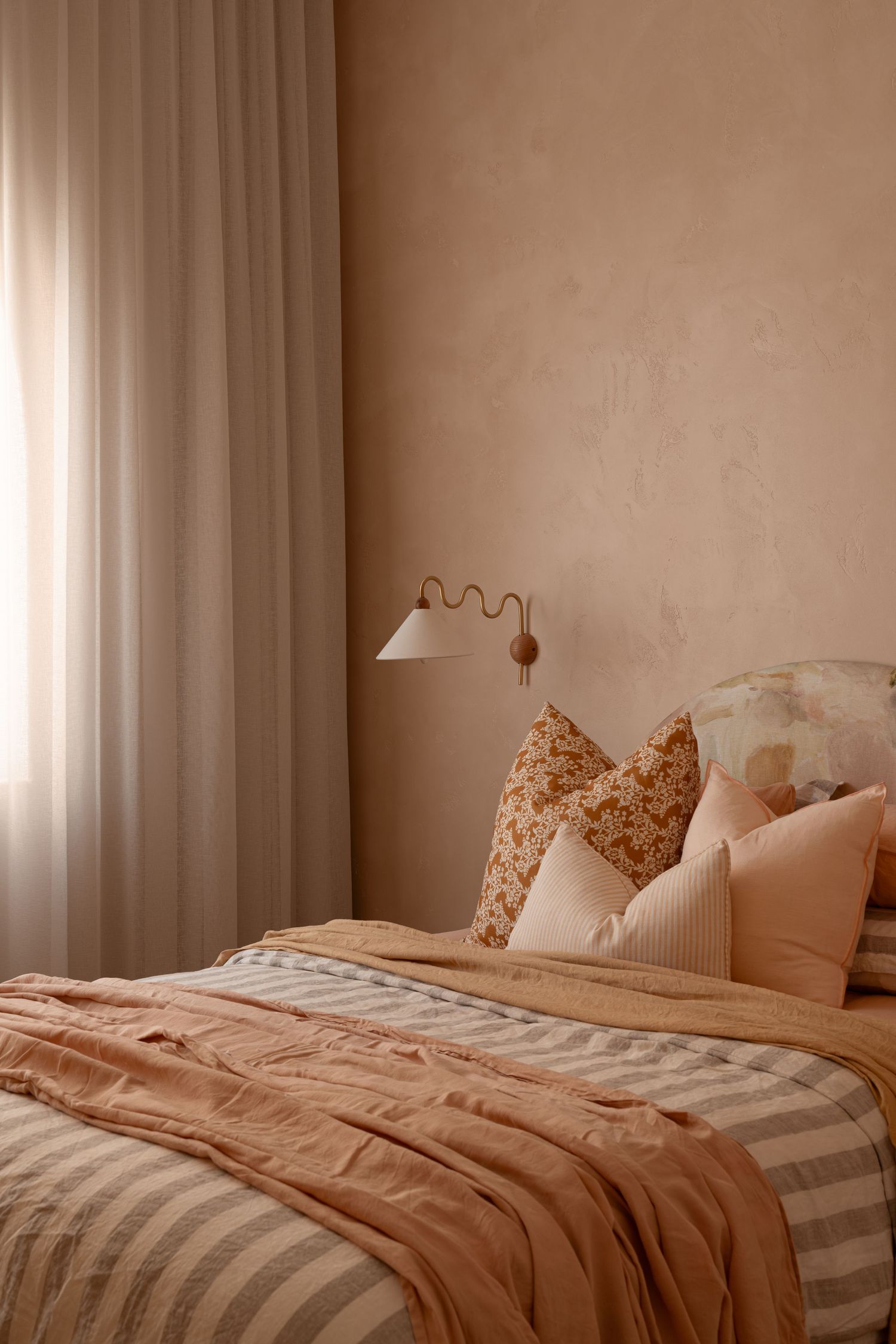 A series of five connected images showing an unmade bed with white and beige bedding in a minimalist bedroom setting.