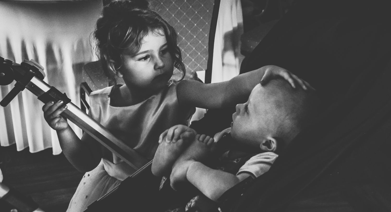Black and white photograph showing a couple in an intimate embrace while sharing a cigarette.