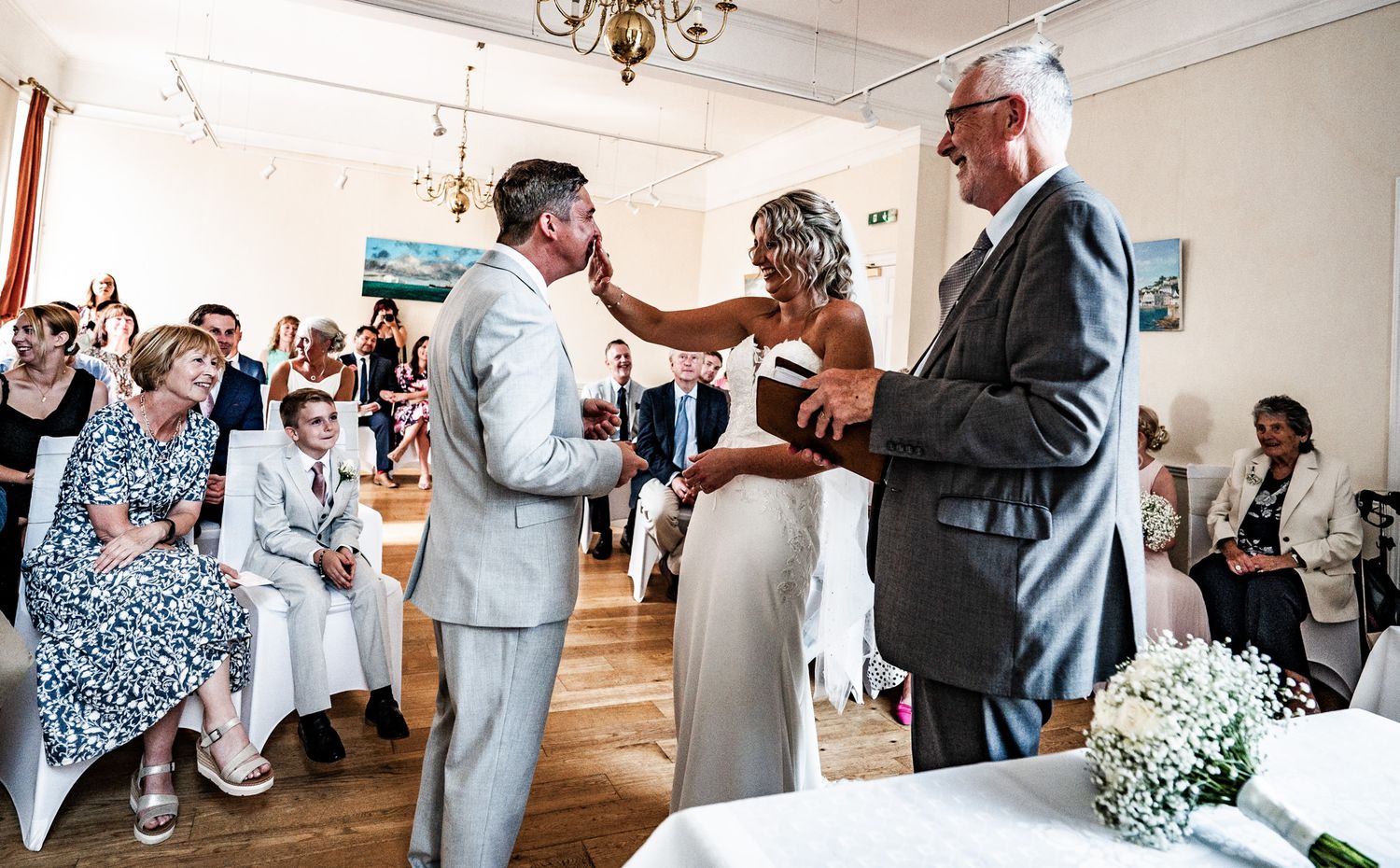 A sequence of wedding reception photos showing guests dancing and celebrating in a bright indoor venue.