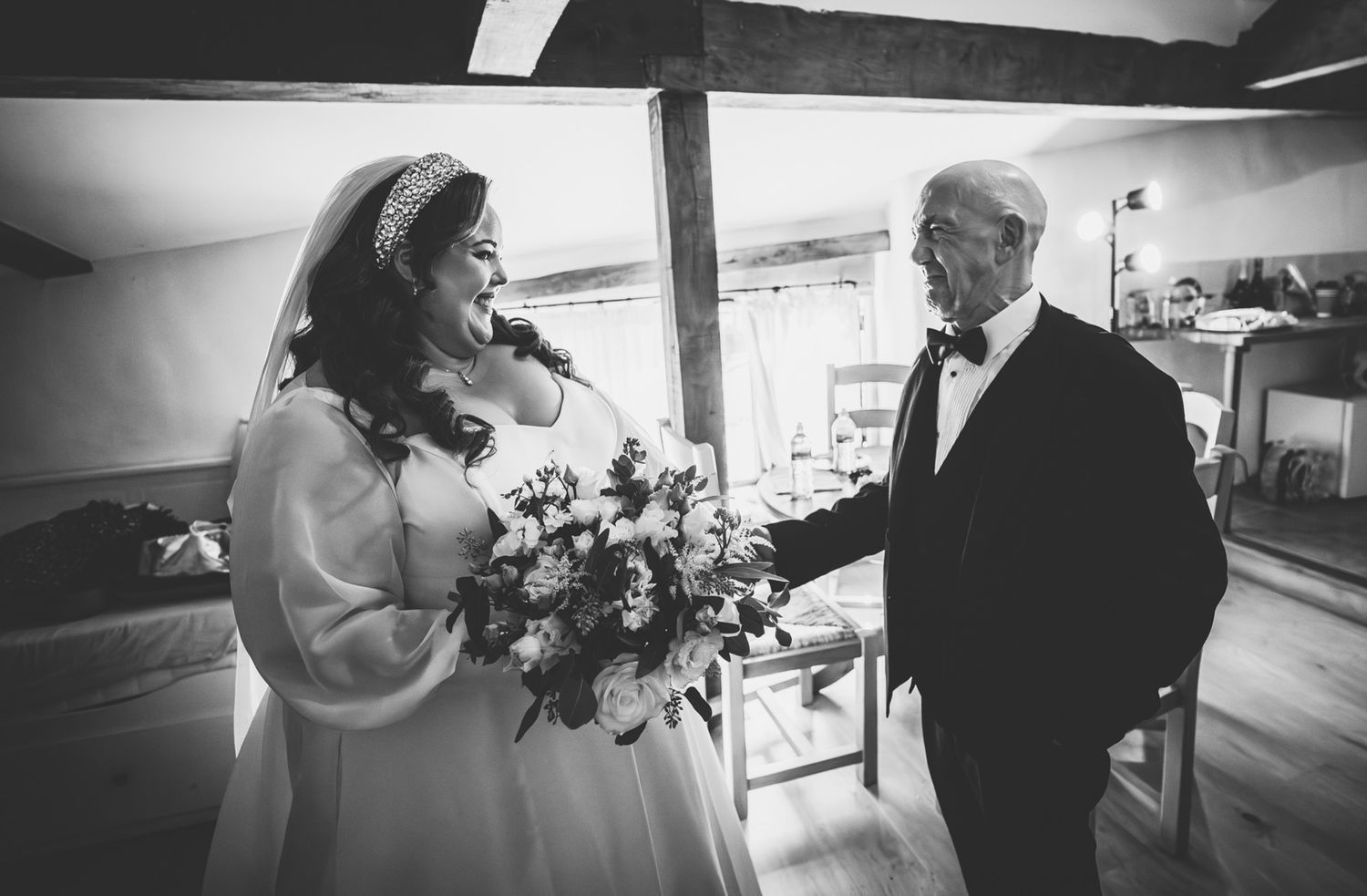 Black and white wedding sequence showing a bride and companion walking together in an elegant indoor venue.