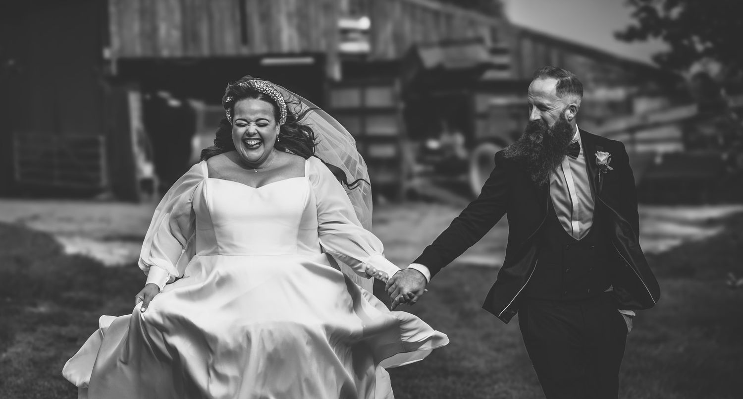 A rustic barn wedding venue with string lights creates a romantic countryside atmosphere.