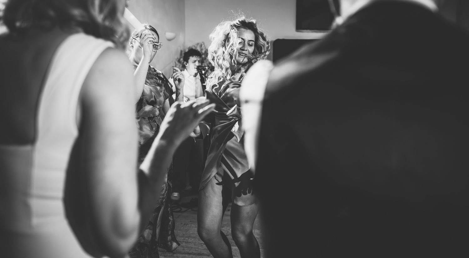 A black and white photo collage showing multiple performance moments on stage with dramatic lighting and movement.