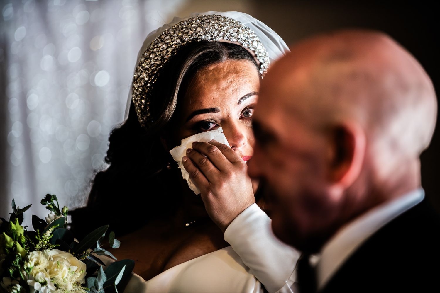 A romantic wedding couple shares an intimate kiss during their celebration.