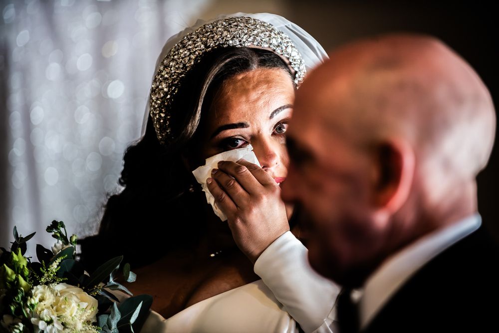 A romantic wedding couple shares an intimate kiss during their celebration.