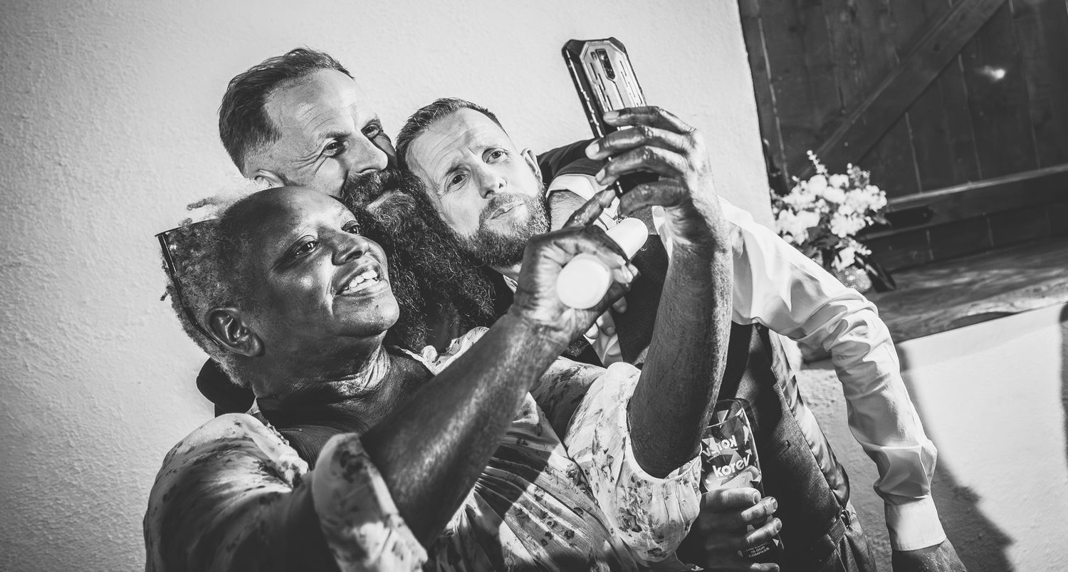 A black and white montage shows several photographers holding vintage cameras and taking pictures at different angles.