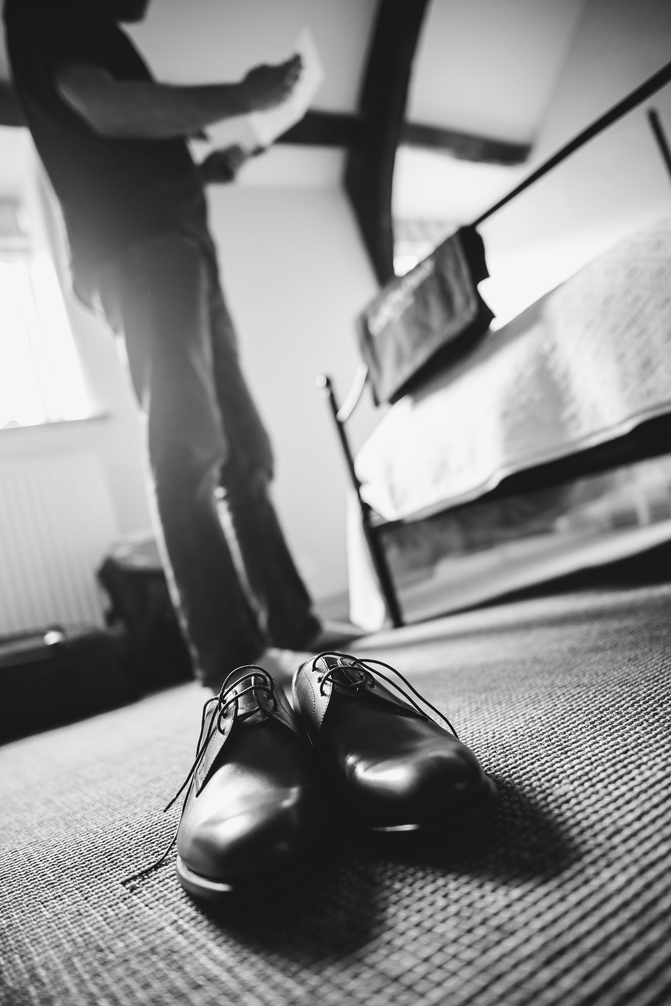 A sequence of black and white photos showing polished dress shoes walking on textured carpet.