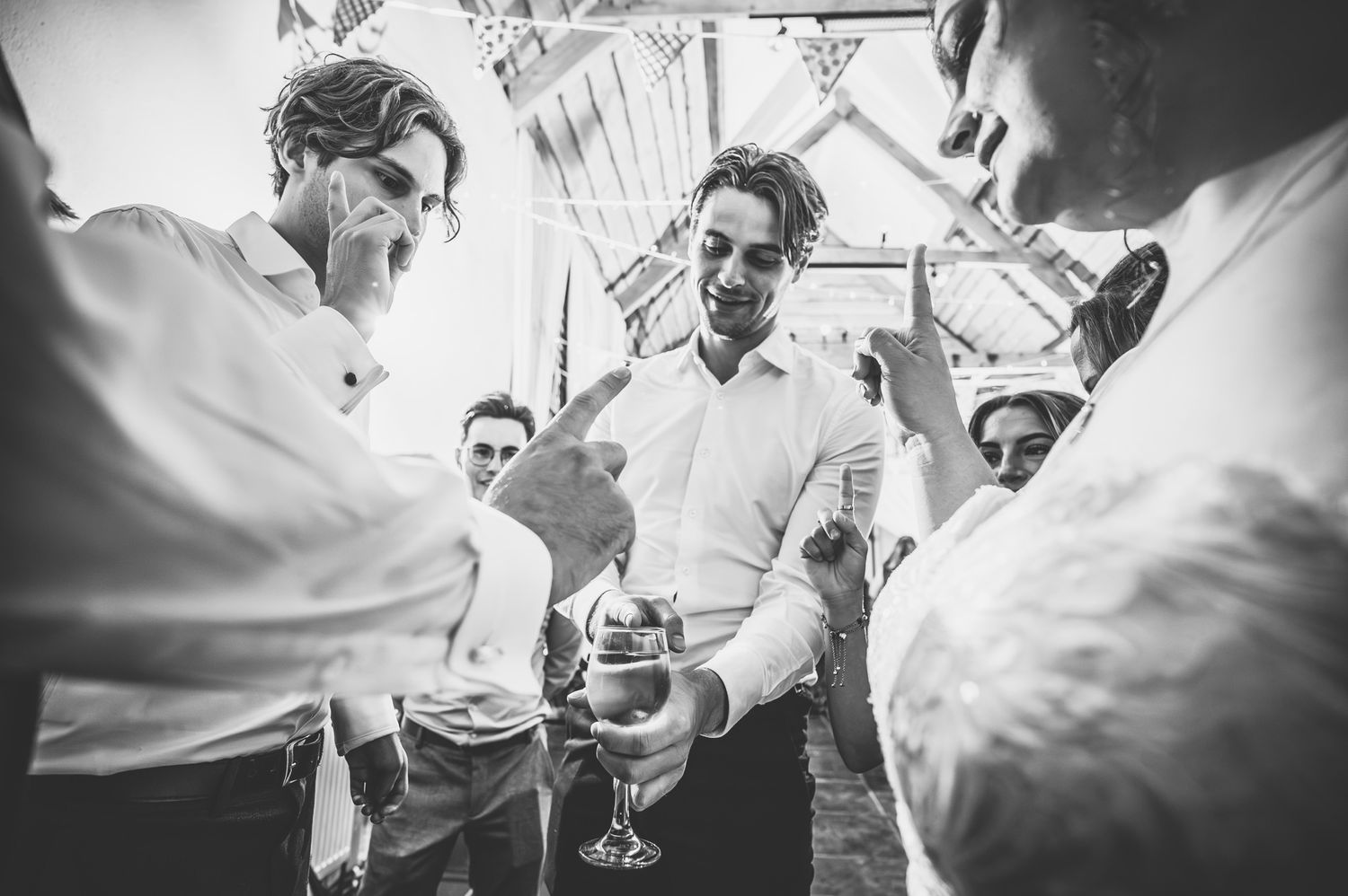 A group of people raise champagne glasses in a celebratory toast at an elegant event.