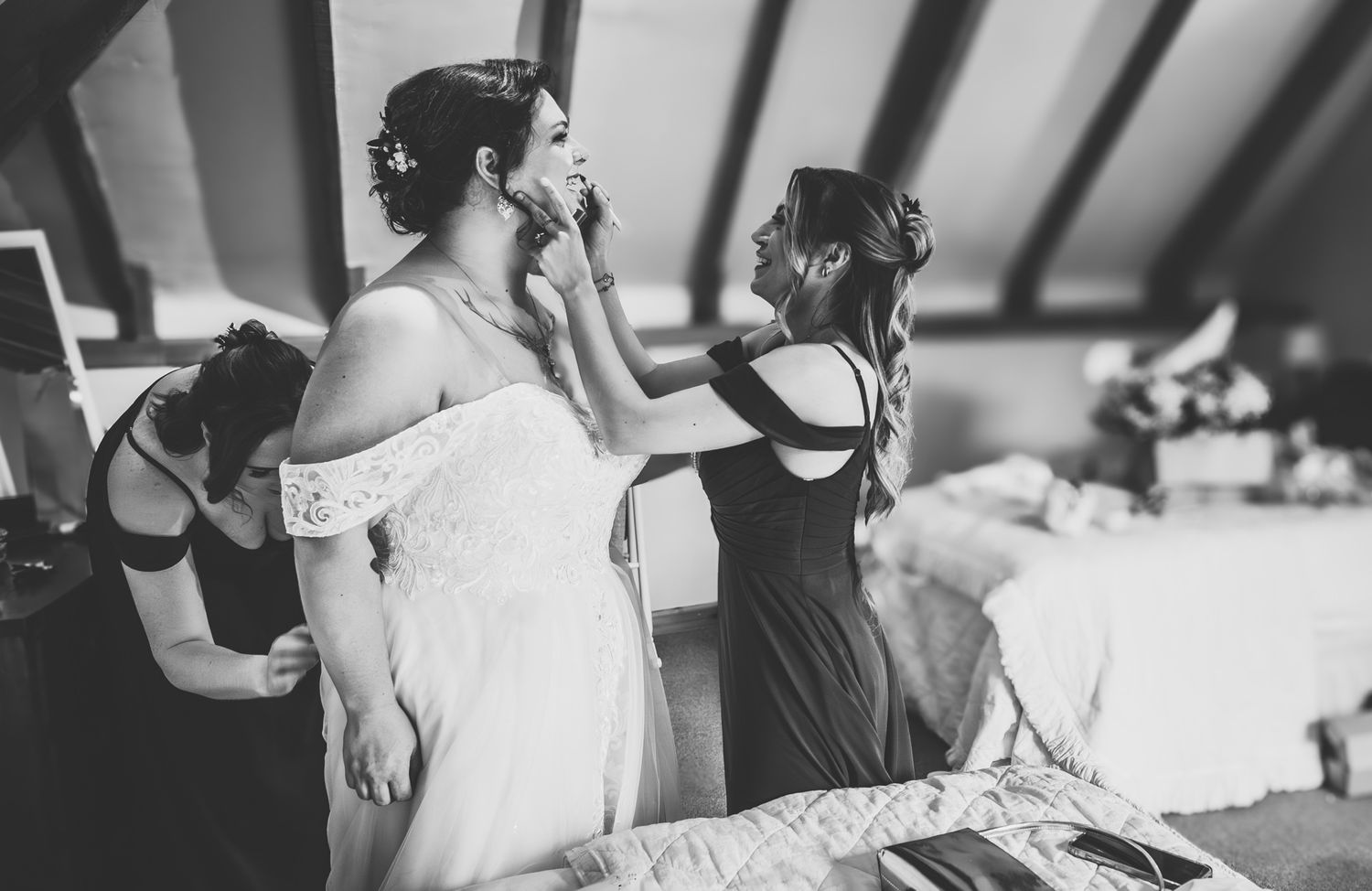A black and white photo series showing candid moments from a wedding celebration with dancing and festivities.