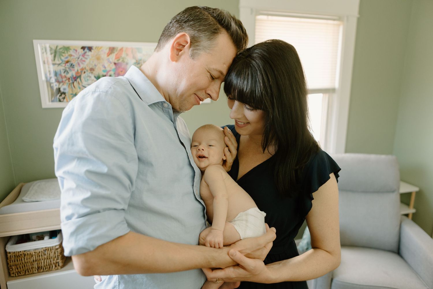 Family sharing tender moment together in bright living room setting.