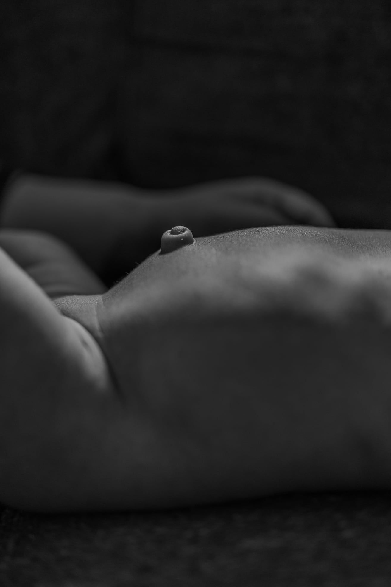Artistic black and white close-up portrait of sleeping newborn.