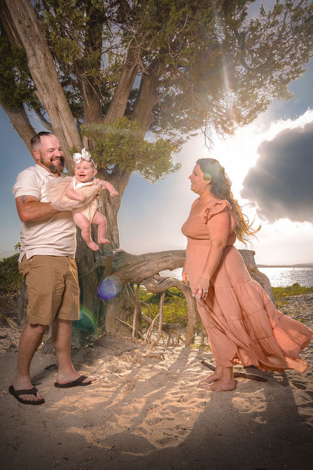 A romantic beach proposal sequence showing a couple in casual attire during sunset under a tree.