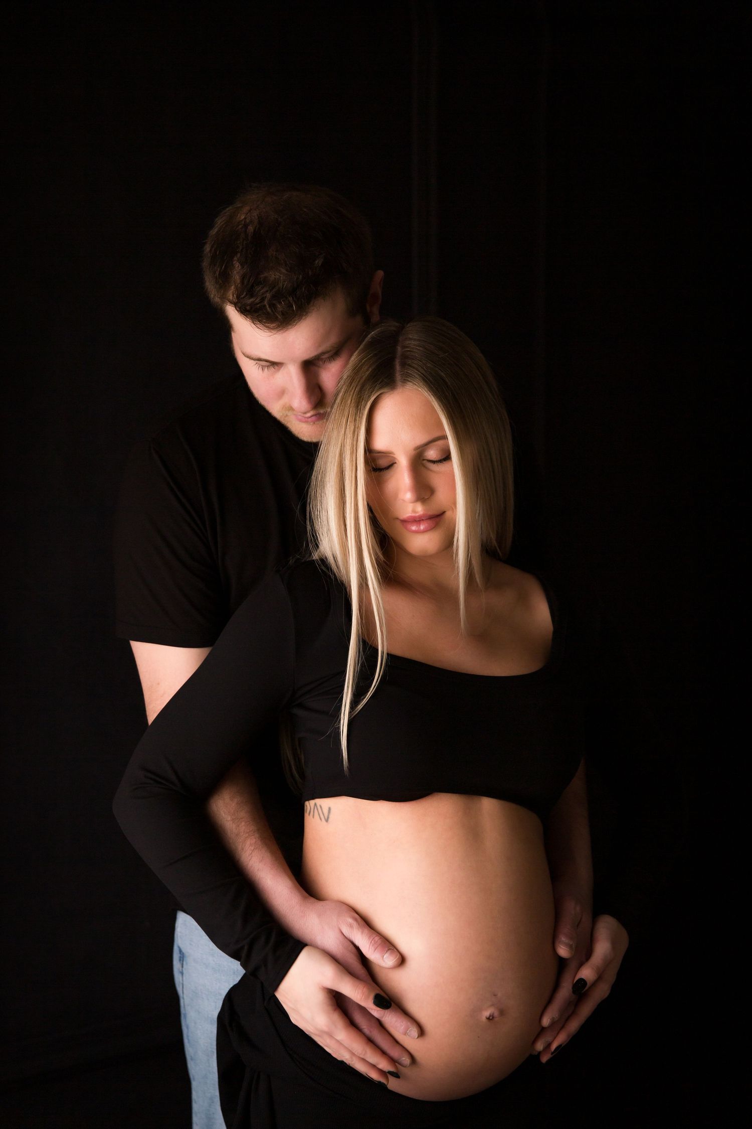 Artistic maternity photography series against dark background.