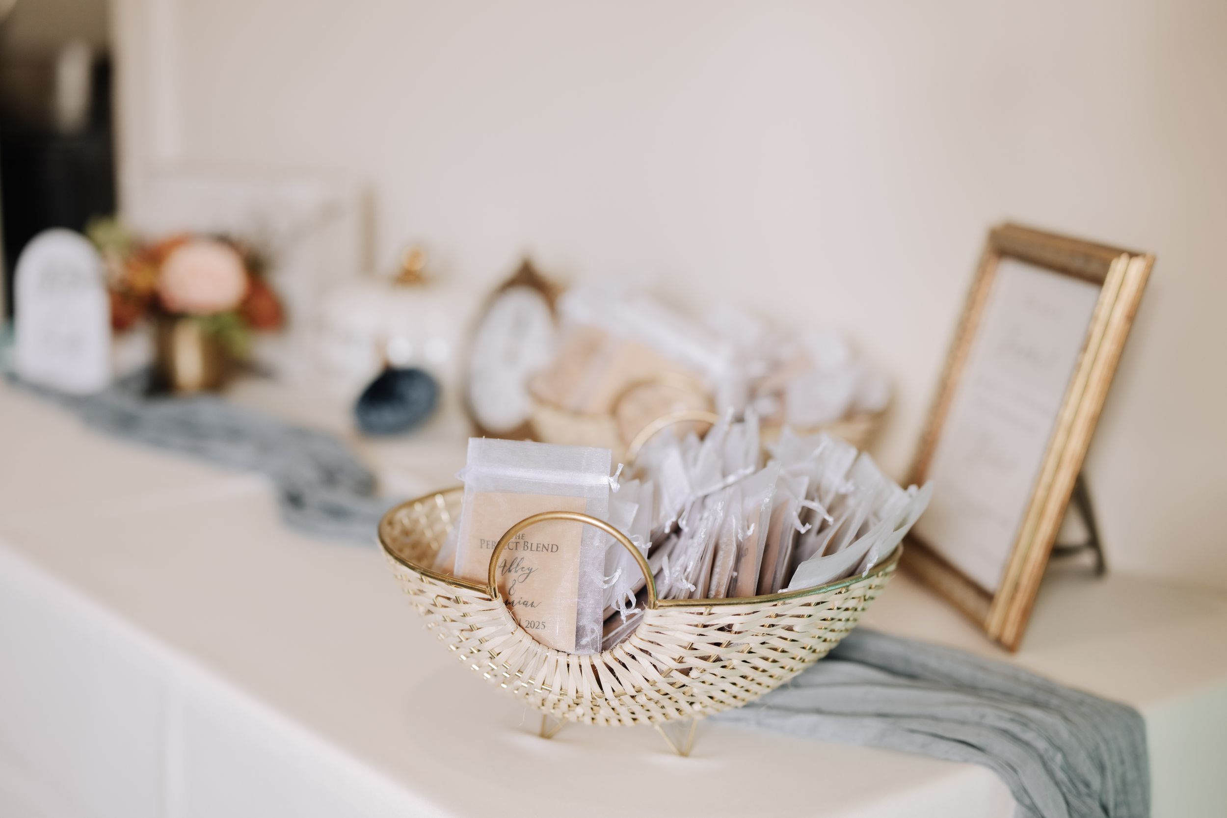 Elegant wedding accessories including pearls, frames, and delicate decor items arranged on a light surface.