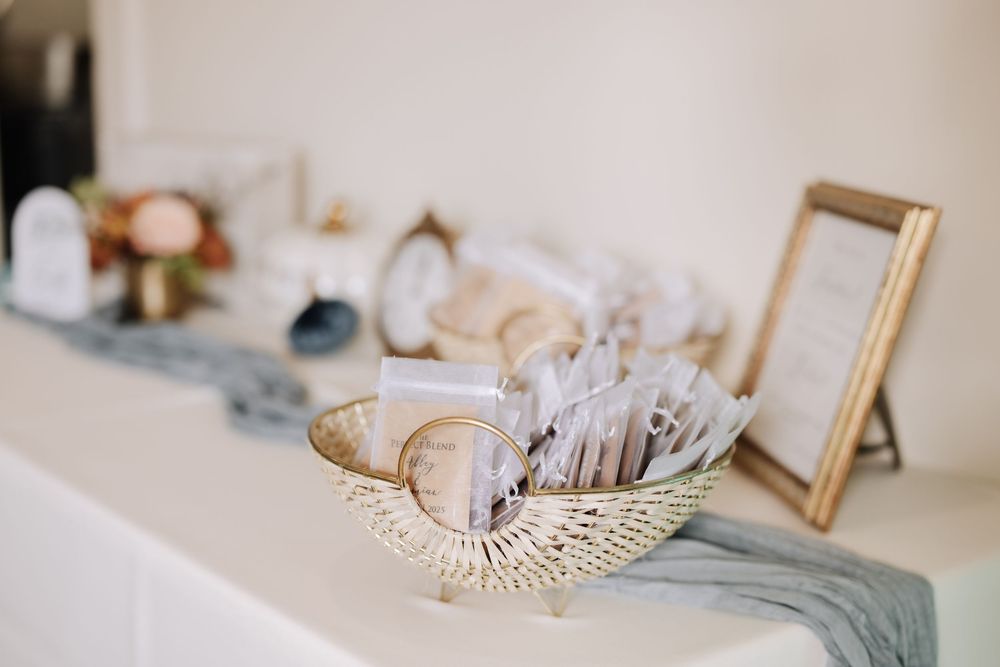 Elegant wedding accessories including pearls, frames, and delicate decor items arranged on a light surface.