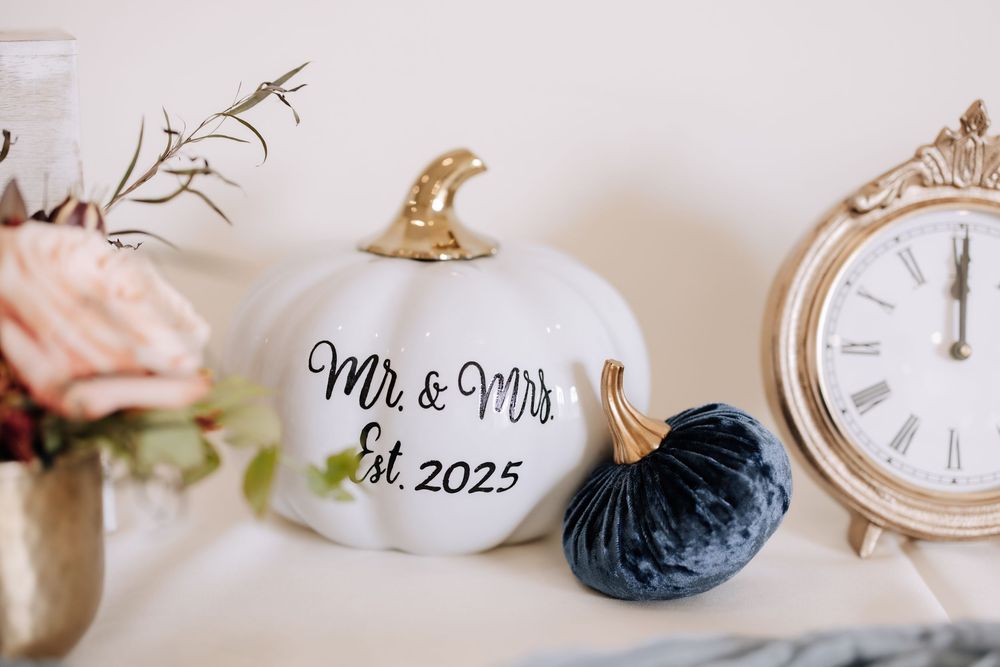 Vintage clocks and wedding decor elements arranged in a minimalist style on a white surface.