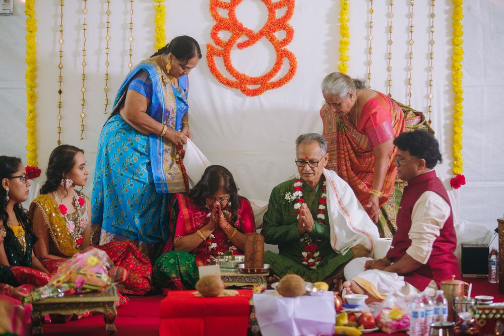 People gather around tables for a traditional Indian cooking class, preparing colorful dishes and ingredients.