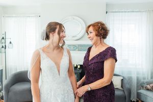 Two people sharing an intimate moment in a bright white room.