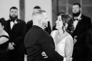 Black and white photo of couples dancing at an elegant wedding reception.