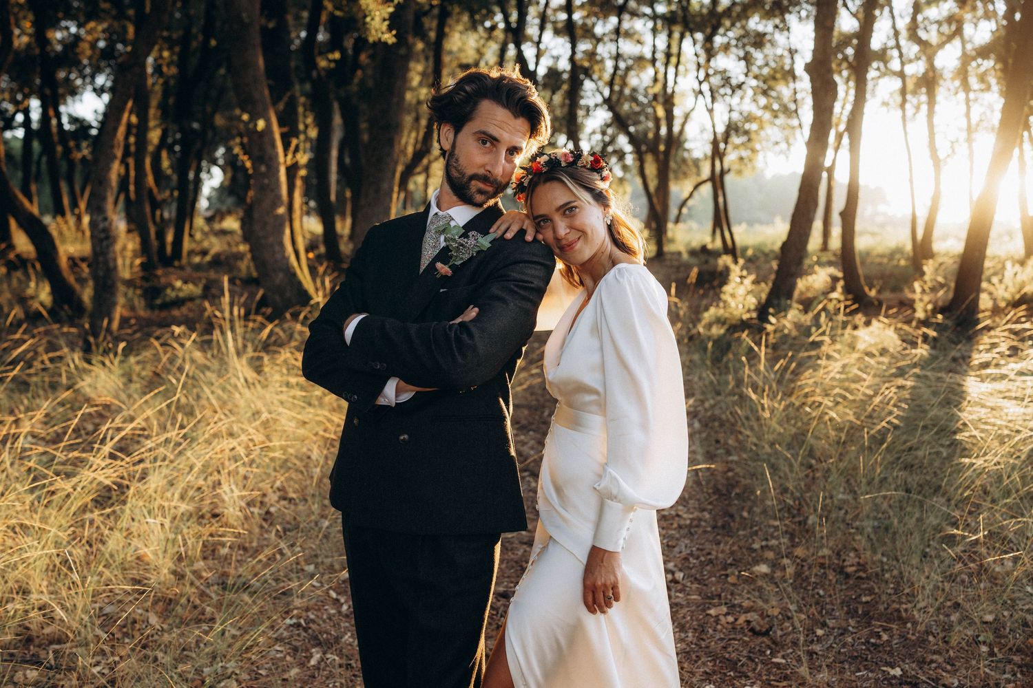 An intimate wedding portrait capturing a tender moment between newlyweds in warm sunset light.