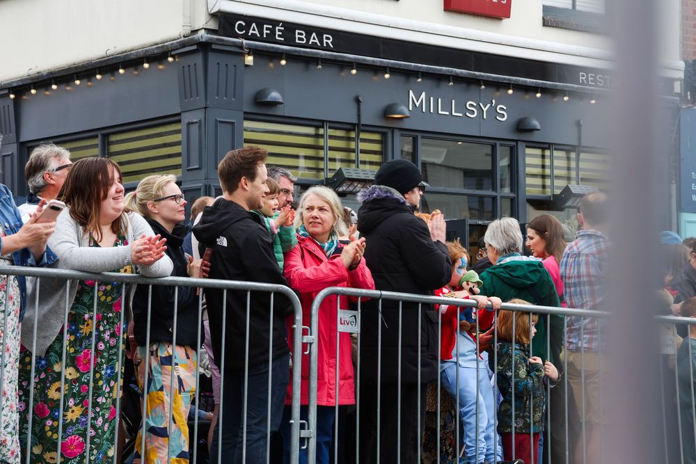 Crowds of spectators gathered outside Millsy's Cafe Bar watching a street performance at Earlsdon festival.