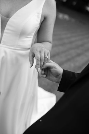 A sequence of close-up shots showing hands with wedding rings in black and white photography.