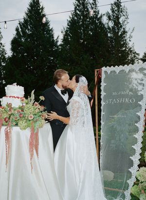Romantic outdoor wedding ceremony setup with floral arrangements and decorative signage.