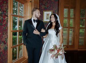 Wedding couple shares playful moments in a rustic indoor setting with wood paneling and floral wallpaper.